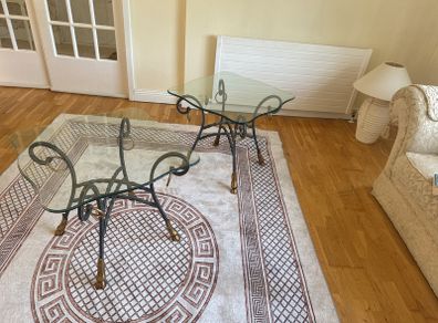 A matching pair of glass tables