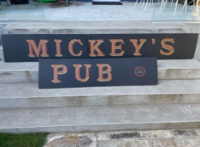 large hand painted "Mickey's Pub" sign