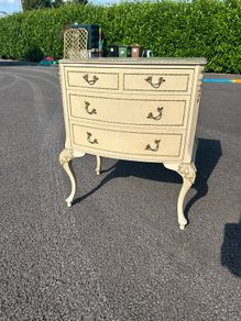 Vintage Olympus cream and gilt Louis style chest of drawers featuring bow-front drawers and cabriole legs.