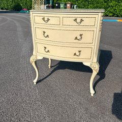 vintage Olympus cream and gilt Louis style chest of drawers featuring bow-front drawers and cabriole legs.