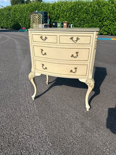 Vintage Olympus cream and gilt Louis style chest of drawers featuring bow-front drawers and cabriole legs.