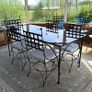 A Luxury Wrought Iron and Smoked Glass Dining Set With 8 Chairs Image 3