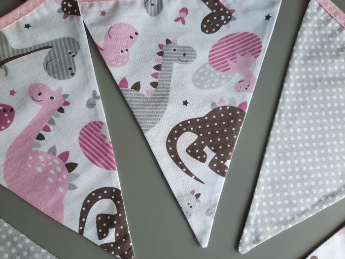 Dinosaur buntings . Blue and pink