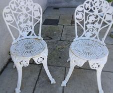 2 cast iron chairs