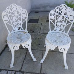 2 cast iron chairs