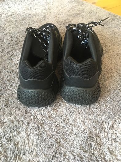 Black trainers bought in Boutique in London