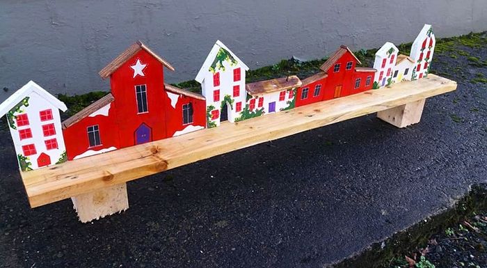 rustic wooden floating shelf display featuring a hand-painted village scene