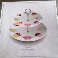 Creative Tops super white porcelain two-tier cake stand featuring a playful pastel cupcake pattern