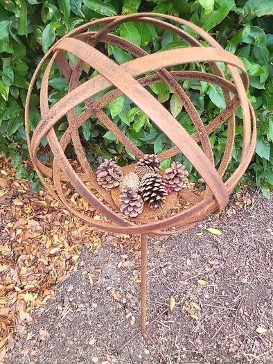 Corten steel garden sphere on a stem