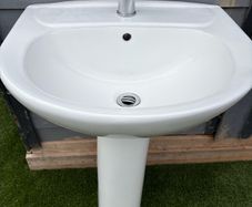 Sink with pedestal and tap