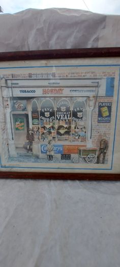 Old advertising shop front picture print ,different brands for sale, in the shop,nice for any home bar or man cave pub restaurant etc,,buyer collects thank you,, rather buyer collects with the glass ,sold as is ,,see pictures for condition