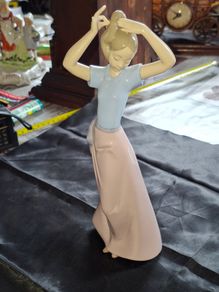 Getting Ready A Young Girl Fixing Her Hair from Nao Porcelain, Lladro, postage available or collection