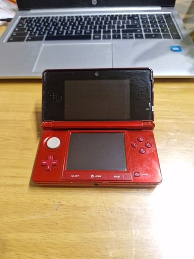 Nintendo 3DS Metallic Red with the original box, charger, and booklets