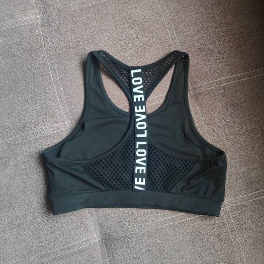 Black sports bra with white lettering, size 10