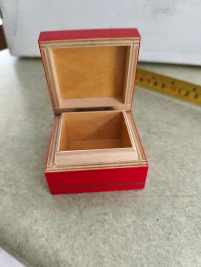 A small wooden trinket / gift box painted red with hand painted flower.