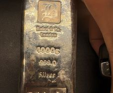 a 1-kilogram silver bar made by Baird & Co. London