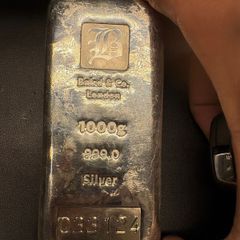 a 1-kilogram silver bar made by Baird & Co. London