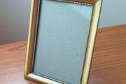 Vintage glazed freestanding gold-toned metal picture frame with classic ornate design size 15x20cm