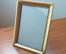 Vintage glazed freestanding gold-toned metal picture frame with classic ornate design size 15x20cm