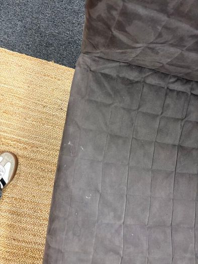 Grey quilted sofa with white metal frame