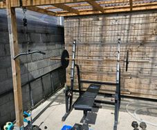 Squat rack + barbell + bumper plates + pull down +