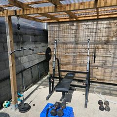 Squat rack + barbell + bumper plates + pull down +