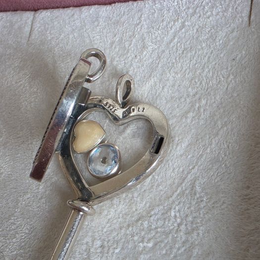 Pandora sterling silver key necklace with a heart,shaped floating locket and pink sparkling stones. Includes the two petite charms