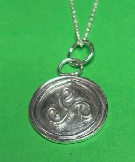 Sterling silver Triskele pendant with 18 inch chain.