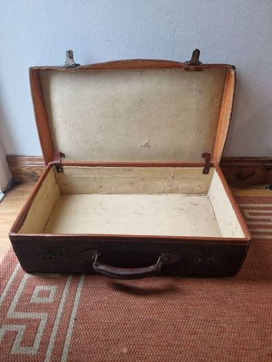 1leather suitcase and 1 faux leather suitcase.