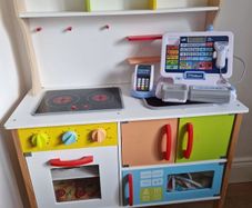 Kid's kitchen with utensils and cash register