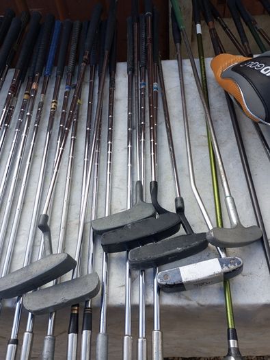 A selection of golf clubs and bags. All right handed clubs.