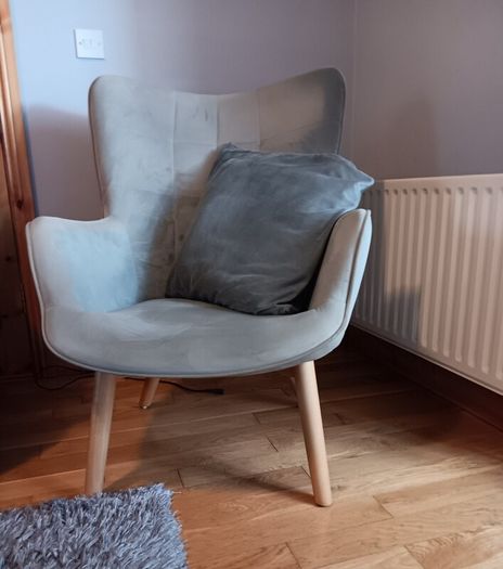 Grey velvet armchair with wooden legs