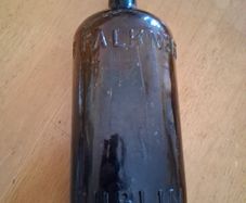 Antique Francis Faulkner Dublin black glass whiskey bottle