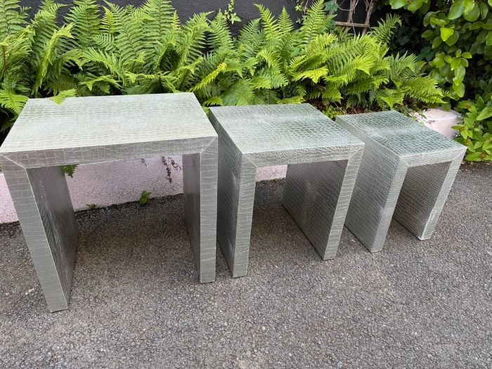 3 silver coloured tables and chest