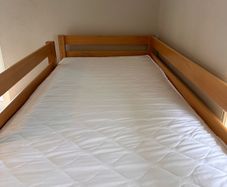 Bunk bed with attached slide and mattresses