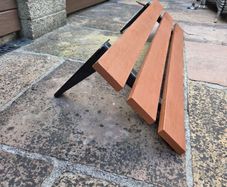 Wall mounted outdoor plastic composite bench with a rust resistant frame