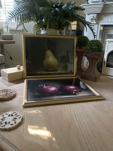 Two gold framed fruit prints.