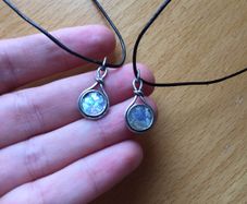 2 x silver pendants with vulcanic glass