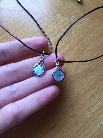 2 x silver pendants with vulcanic glass