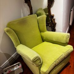 Green high back armchair with arm covers