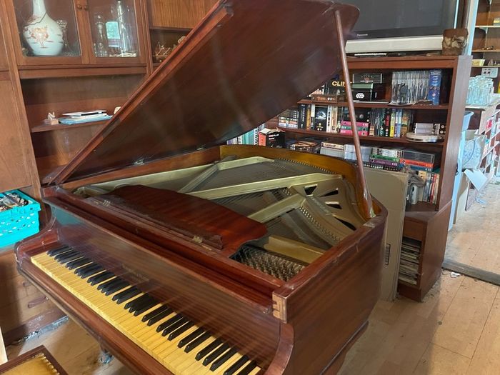 a circa-1931 Monington & Weston baby grand with matching stool.