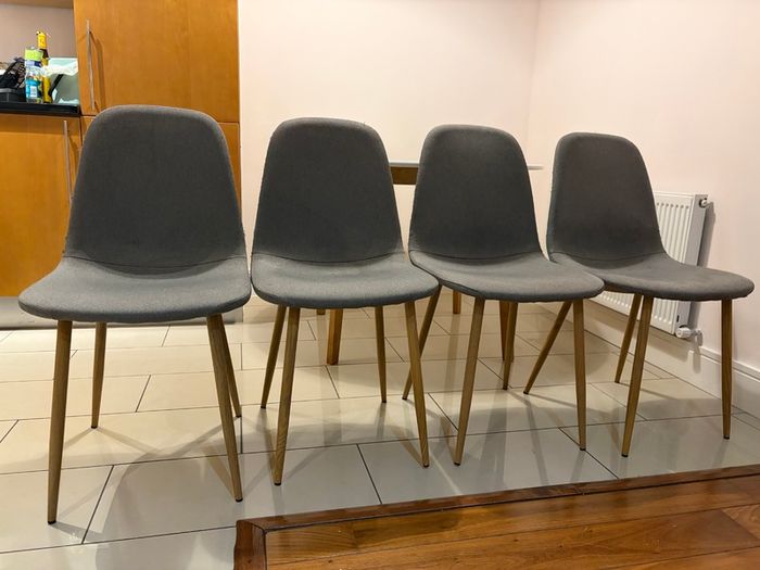 Round dining table with four grey fabric chairs