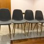 Round dining table with four grey fabric chairs Image 2