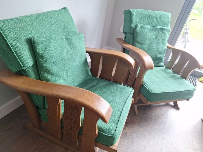 Pair of green arm chairs.
