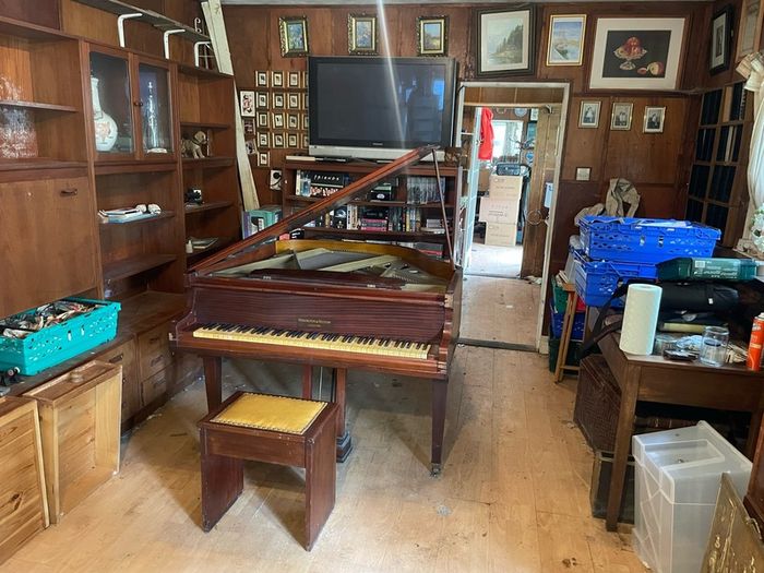 a circa-1931 Monington & Weston baby grand with matching stool.