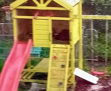 Garden playhouse with slide, swings, look out tower, picnic table