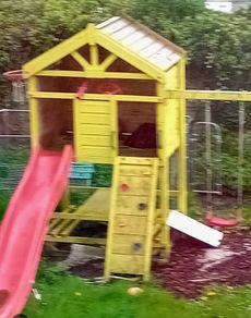 Garden playhouse with slide, swings, look out tower, picnic table