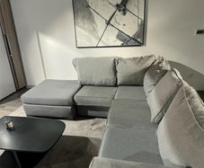 Grey corner sofa with matching footstool