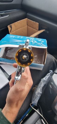 Paint spray gun with pot tank, a W-77 model nozzle.