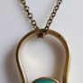 Vintage necklace features a polished, knocker-shaped pendant  gold plated, centered with an iridescent turquoise Spinning Fob Image 4